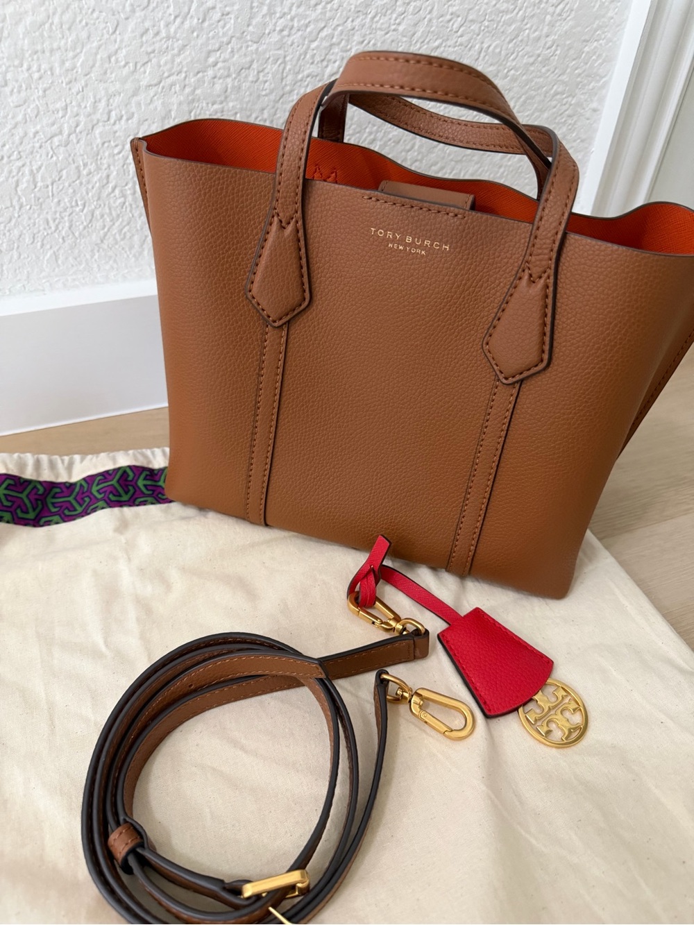 Tory Burch Tan Pebbled Leather Tote with Red Charm